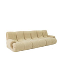 Cookies curved bouclé lounge sofa with pillowy segmented silhouette, premium upholstery, and solid beech wood frame for modern luxury interiors.