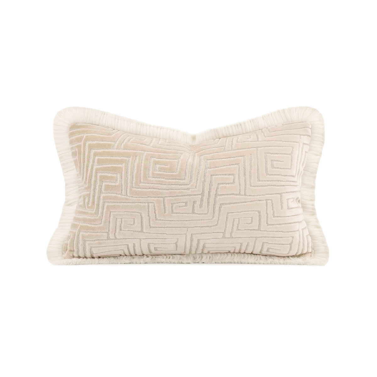 A rectangular lumbar throw pillow in cream with a raised geometric Greek key pattern and fringed edges, shown on a solid white background.