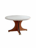Babeta round dining table with natural off-white travertine top, sculptural white waxed ash wood base, and metal accents for modern luxury interiors.