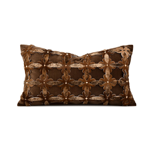 A rectangular brown throw pillow featuring an intricate 3D geometric pattern of interlocking floral and lattice motifs in varying shades of brown, accented with small metallic gold studs, shown against a plain white background.