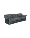 A three-seater sofa with a textured black and gray patterned upholstery and a solid black side panel,  living room sofa, modern textured pattern dark fabric upholstery, solid European beech wood frame, quiet luxury moody dark aesthetic designer home furniture.